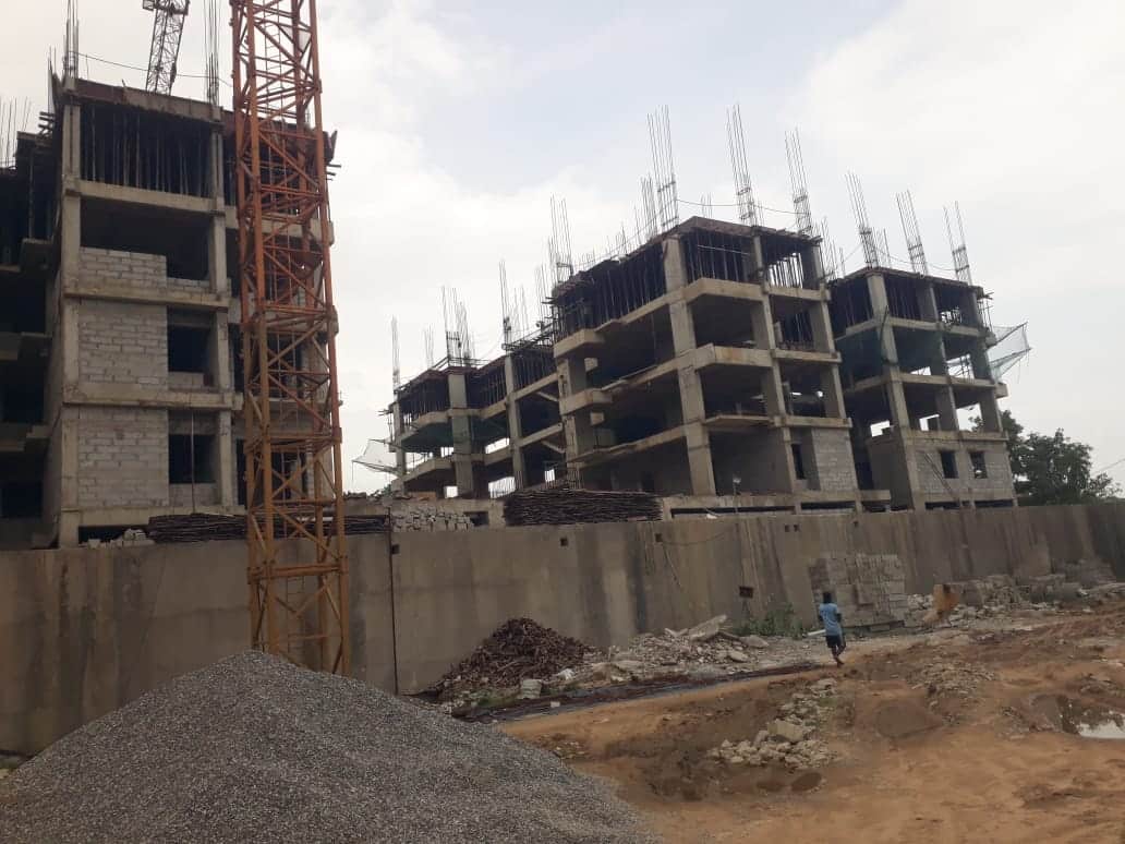 a construction site with a crane and a building